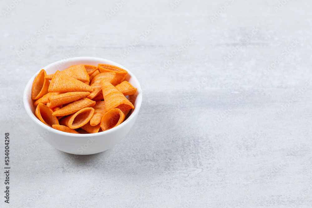Delicious crunchy chips in white bowl Delicious crunchy chips in white bowl
