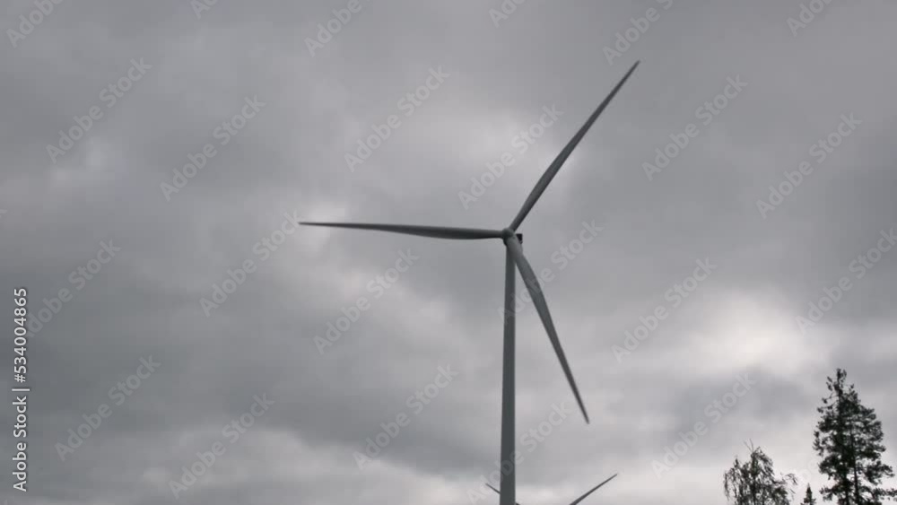 Wind turbine slowly rotating against the cloudy sky
Wind turbine slowly rotating against the cloudy sky