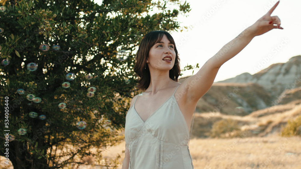 Girl dances among soap bubbles in the countryside in nature Girl dances among soap bubbles in the countryside in nature