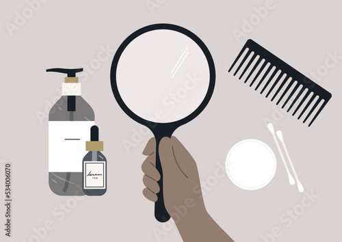 Daily styling kit, a mirror, a hair comb, beauty products in glass bottles, cotton swabs and discs