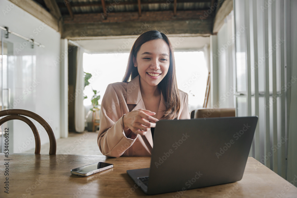 Attractive and happy young female Asian student studying online, sitting at desk, using laptop computer, having video chat, waving, education concept. Attractive and happy young female Asian student studying online, sitting at desk, using laptop computer, having video chat, waving, education concept.