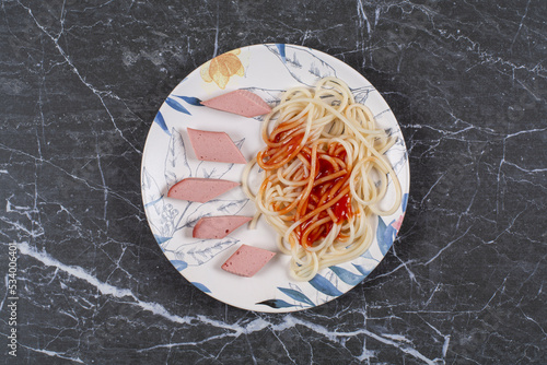 Top up photo of Fresh boiled spaghetti with sausage and ketchup photo