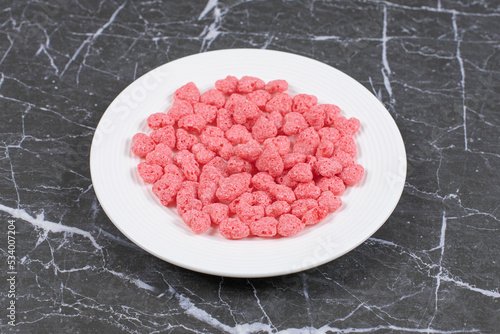 Pink cereal flakes on white plate