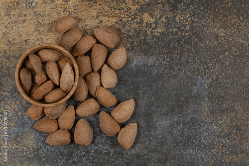 Organic shelled almonds in wooden bowl