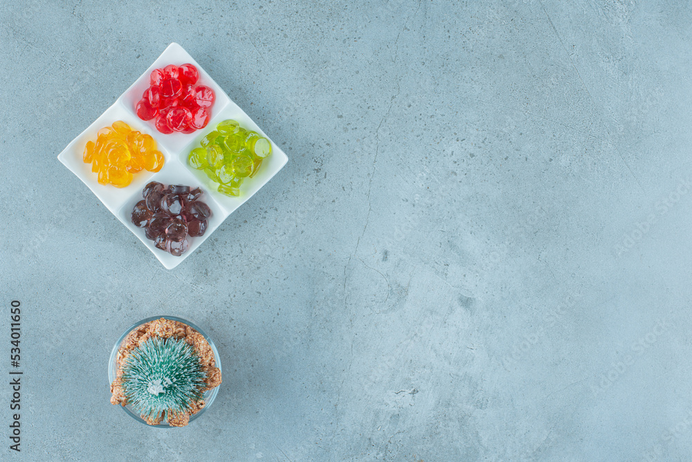 Colorful jelly candies with a Christmas tree on a marble background Colorful jelly candies with a Christmas tree on a marble background