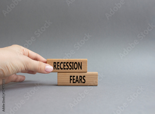Recession fears symbol. Concept words Recession fears on wooden blocks. Beautiful grey background. Businessman hand. Business and Recession fears concept. Copy space.