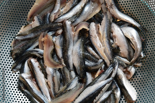 Closeup shot of a metal bowl of anchovies