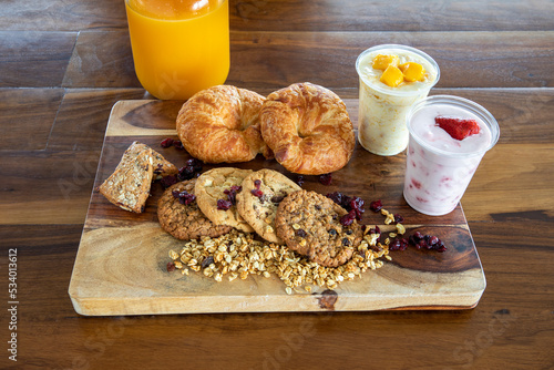 Croissants, cookies and yogurth as breakfast items photo