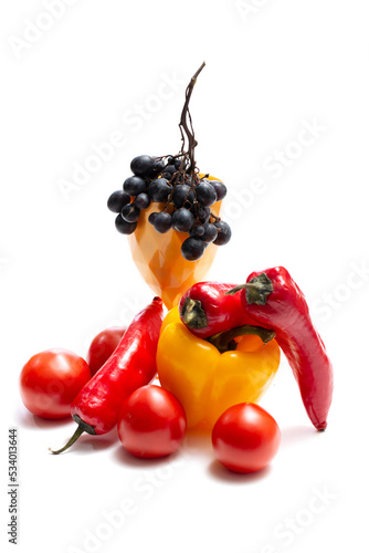 Grapes, peppers and tomatoes on a white background