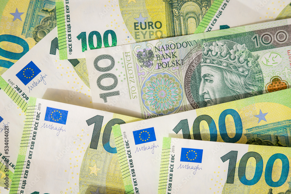 Euro banknotes and 100 polish zloty wallpaper. Close up of money. Wealth concept, free trade, business concept and inflation in Europe Euro banknotes and 100 polish zloty wallpaper. Close up of money. Wealth concept, free trade, business concept and inflation in Europe
