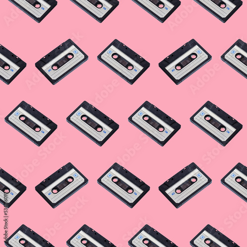 Seamless pattern of audio cassettes on a pink background, retro devices.