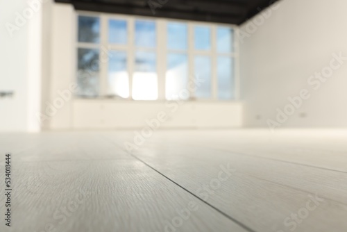 Empty room with new white laminated flooring, closeup