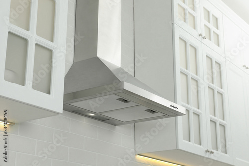 Foto Modern range hood on white brick wall in kitchen