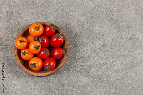Delicious tomatoes in the bowl , on the marble background