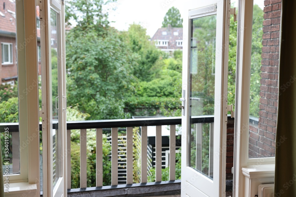 Beautiful view on balcony and inner yard with green trees from apartment Beautiful view on balcony and inner yard with green trees from apartment