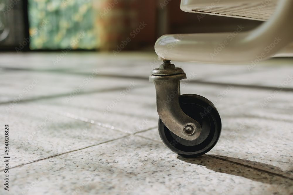 Close up of old portable cabinet wheel on the floor. Close up of old portable cabinet wheel on the floor.