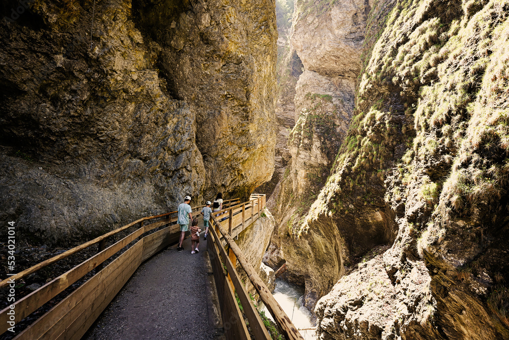 Mother hikking with four kids in Liechtensteinklamm or Liechtenstein Gorge, Austria. Mother hikking with four kids in Liechtensteinklamm or Liechtenstein Gorge, Austria.