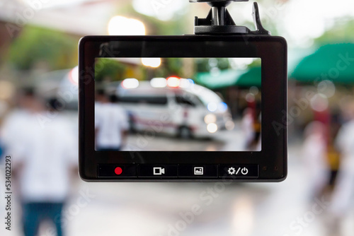 Car CCTV camera video recorder with ambulance car on the road photo