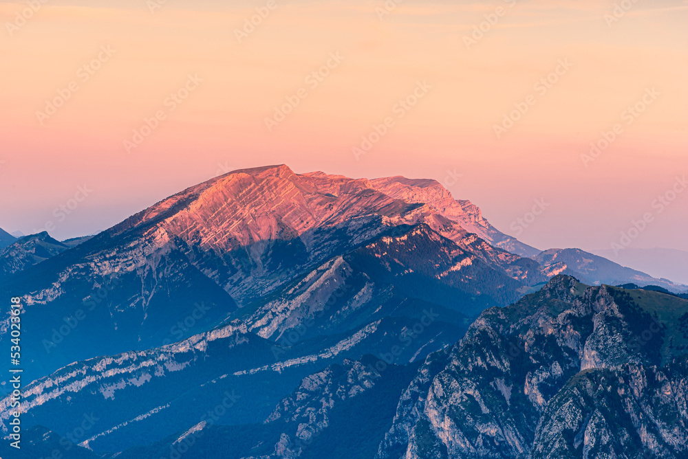 Beautiful crimson light at sunrise over the mountain peak.
