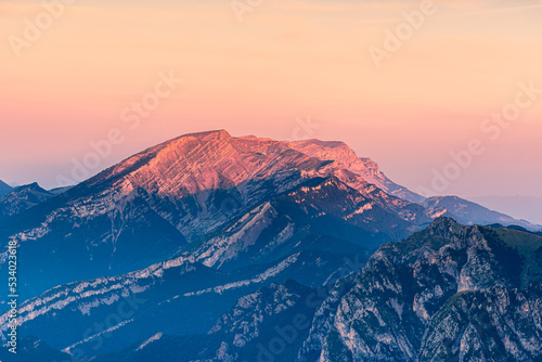 Beautiful crimson light at sunrise over the mountain peak. © zkcristian