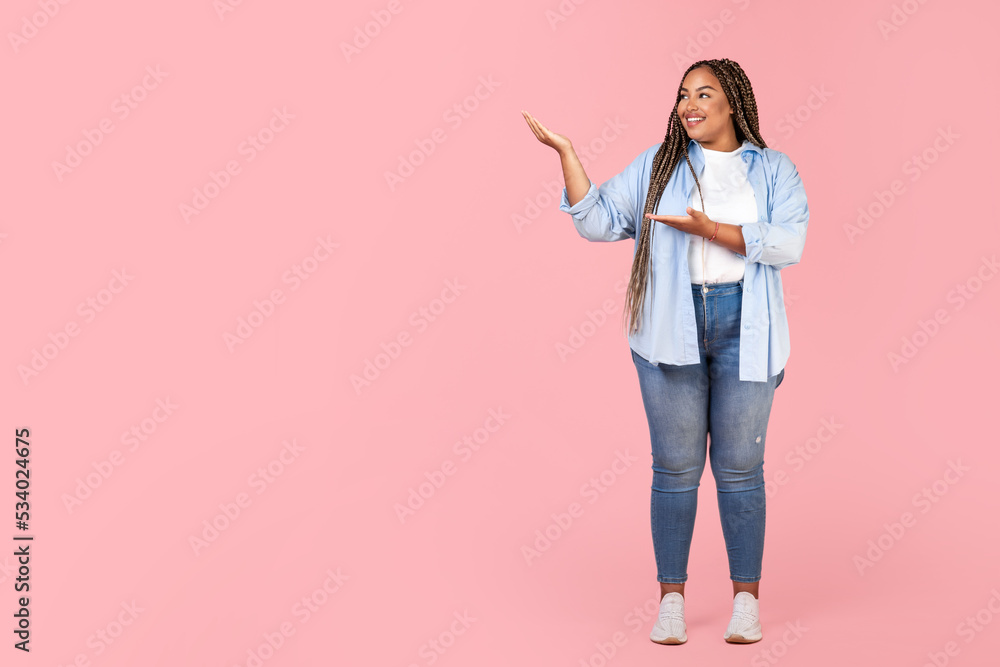 African Oversized Woman Pointing Aside Showing Copy Space, Pink Background African Oversized Woman Pointing Aside Showing Copy Space, Pink Background