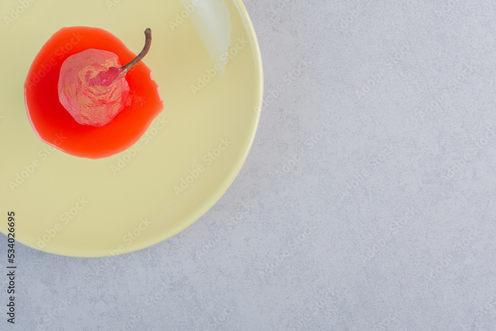 Red pear with sweet sauce on yellow plate Red pear with sweet sauce on yellow plate