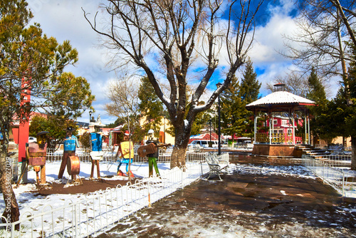 village on snow winter with dry trees and cloudy sky , creel chihuahua mexico 