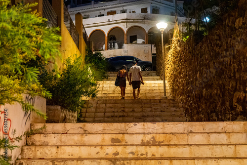 Couple walking night city in Torremolinos, Spain on September 2, 2022