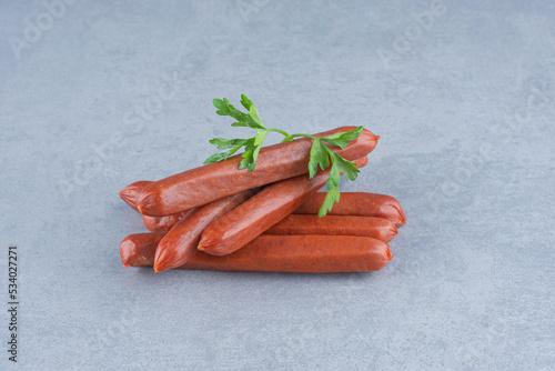 Fresh Salami and parsley on grey background photo