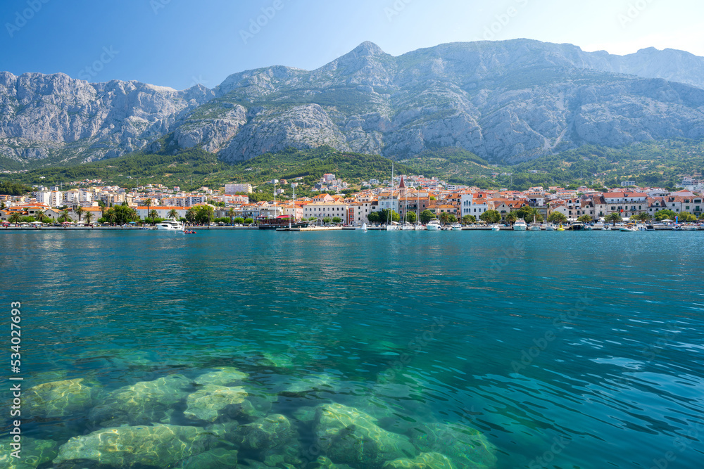 view on Makarska town with azure adriatic sea and Biokovo mountains in Dalmatia region in Croatia