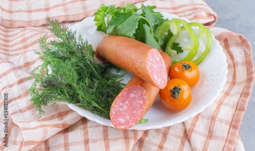 Food tray with delicious salami, tomatoes, salad and vegetable