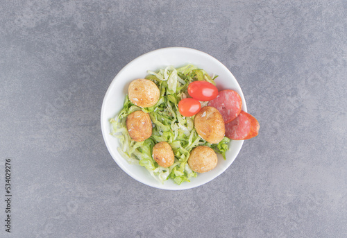 A plate of fresh salad ,on the marble background