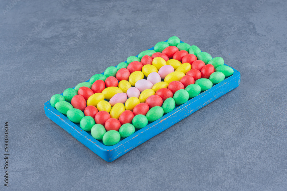 A bowl of colorful gums , on the marble background A bowl of colorful gums , on the marble background