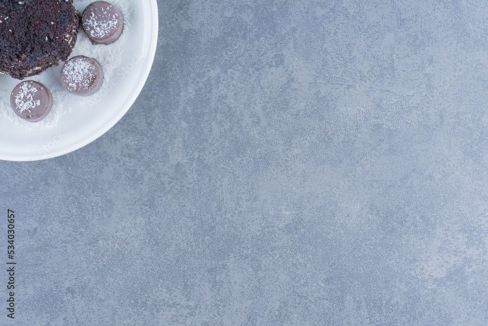 Chocolate cake and sweet cookie, on the marble background Chocolate cake and sweet cookie, on the marble background
