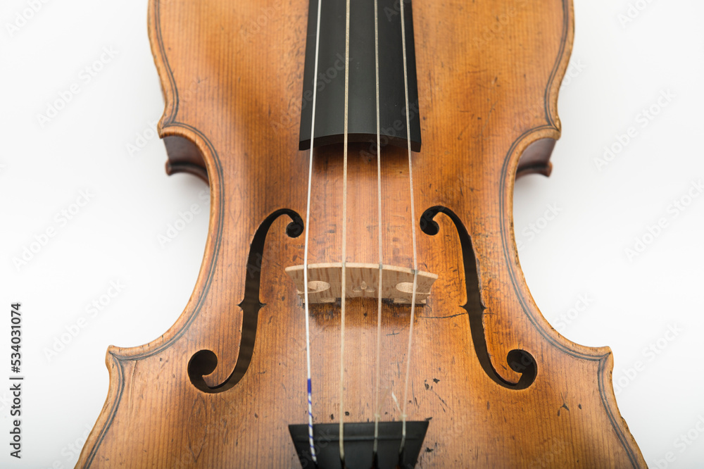 Close up of violin bridge with f-holes. Close up of violin bridge with f-holes.