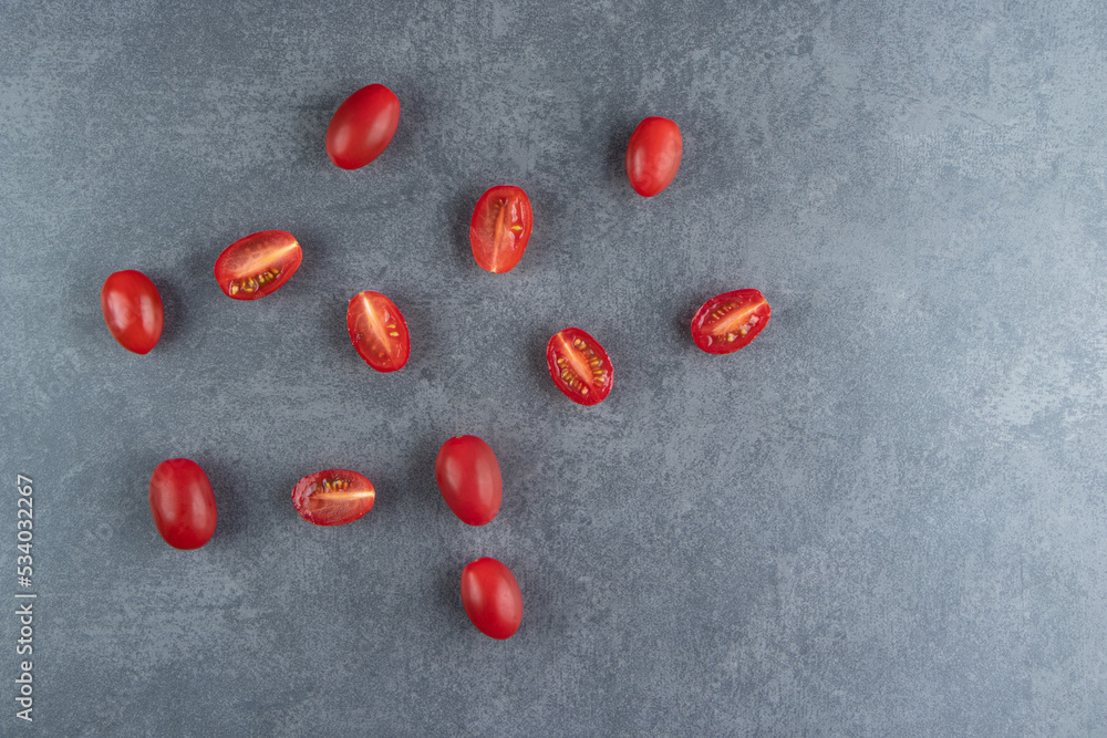 Many of red cherry tomatoes on a marble background Many of red cherry tomatoes on a marble background
