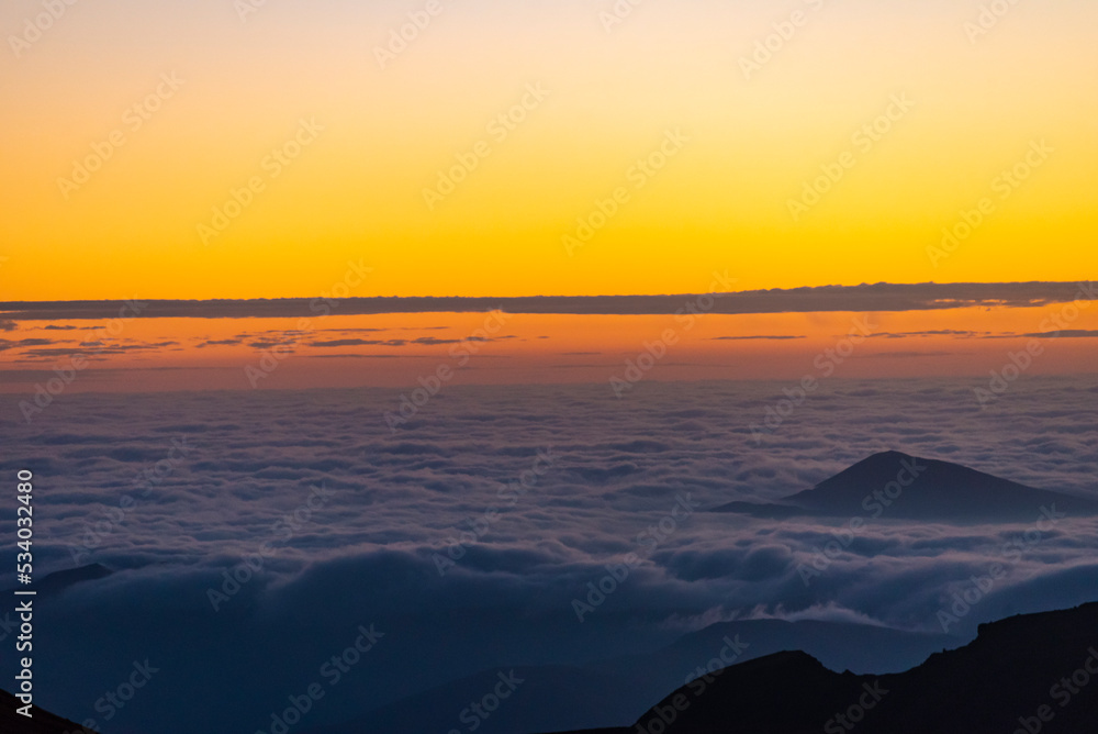 Fototapeta premium Panoramic view form mountains peak on the bright sunset with clouds.