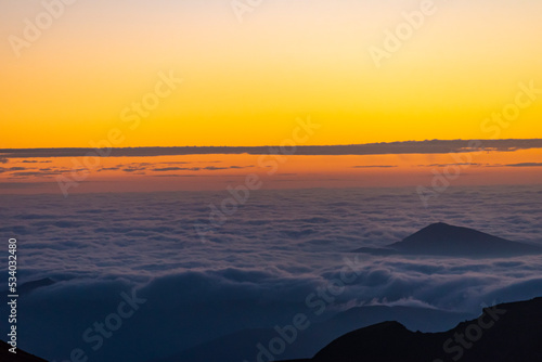 Panoramic view form mountains peak on the bright sunset  with clouds. © Karo