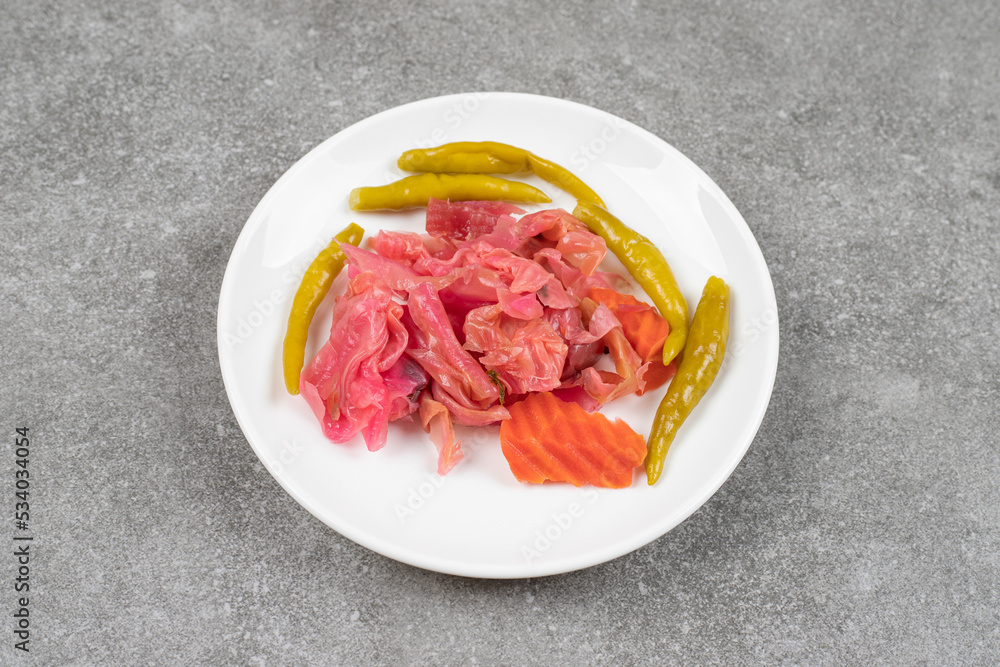 Assortment of homemade pickles on white plate