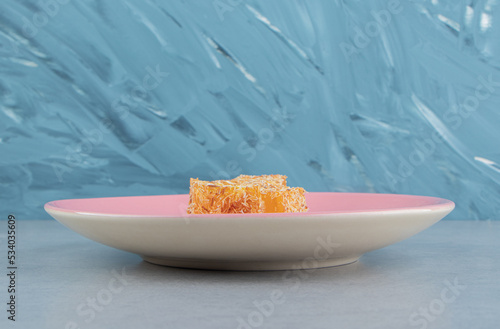 Sweet yellow Turkish delight on the marble, on thee blue background photo