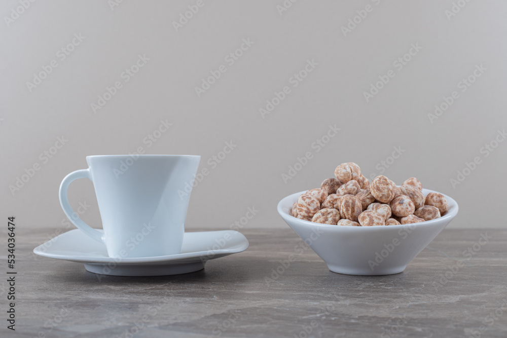A cup of tea and confectionery on the marble background A cup of tea and confectionery on the marble background
