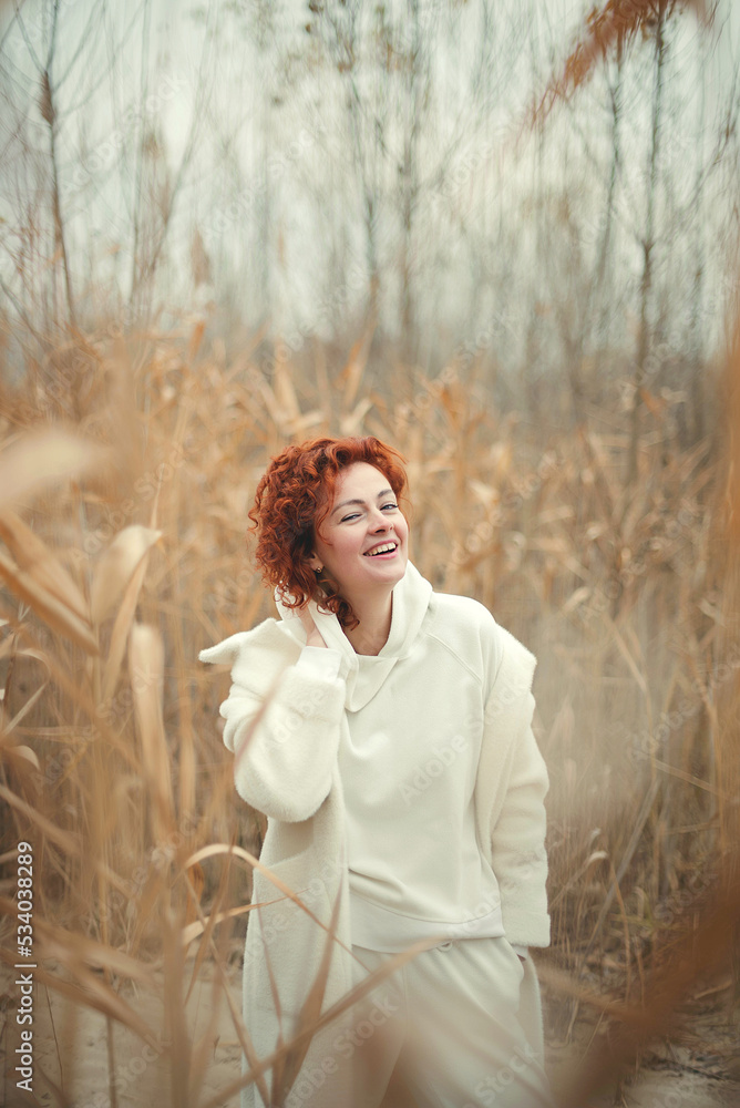 Portrait of a beautiful happy woman with a smile with an autumn in the park Portrait of a beautiful happy woman with a smile with an autumn in the park