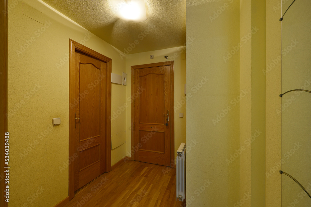Distributor of a house with oak doors, matching floors and yellow walls Distributor of a house with oak doors, matching floors and yellow walls