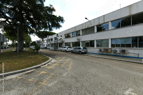 Facades and office parking area in industrial buildings with white facades