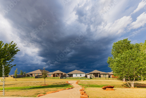 Sunny view of a community with storm clouds overhead