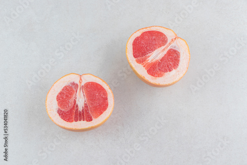 Ripe sliced grapefruits on stone background