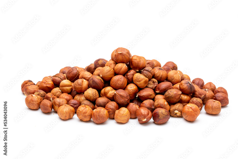 Heap of hazelnuts close-up. Peeled nuts. Hazelnut isolated on white background. Heap of hazelnuts close-up. Peeled nuts. Hazelnut isolated on white background.