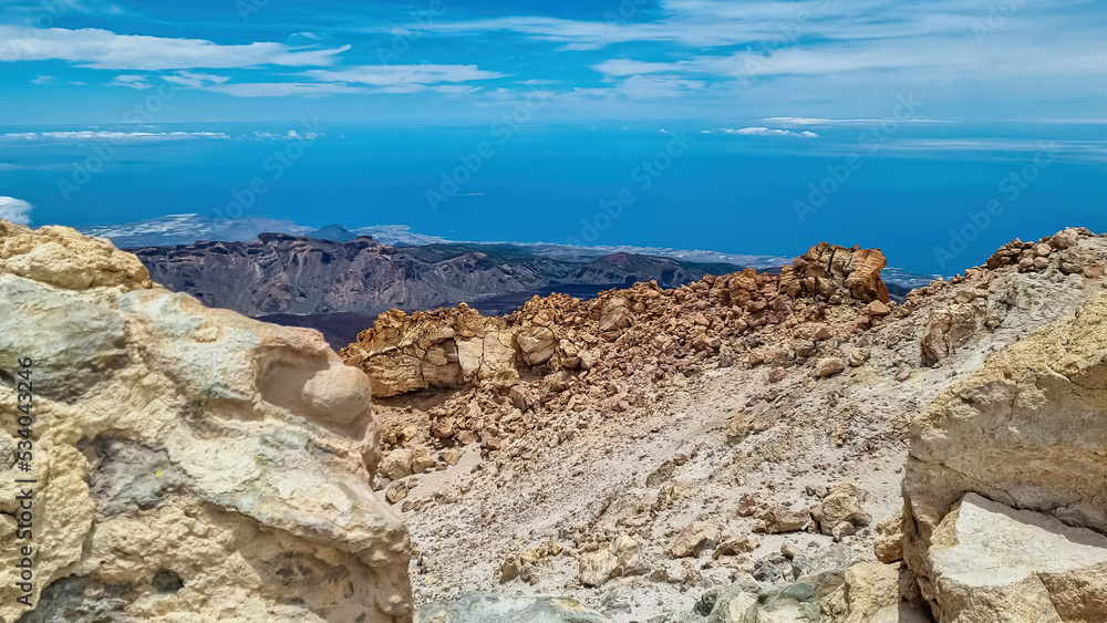 Panoramic view on volcanic desert terrain near summit of volcano Pico del Teide, Mount Teide National Park, Tenerife, Canary Islands, Spain, Europe. Solidified lava, ash, pumice. Clouds accumulating