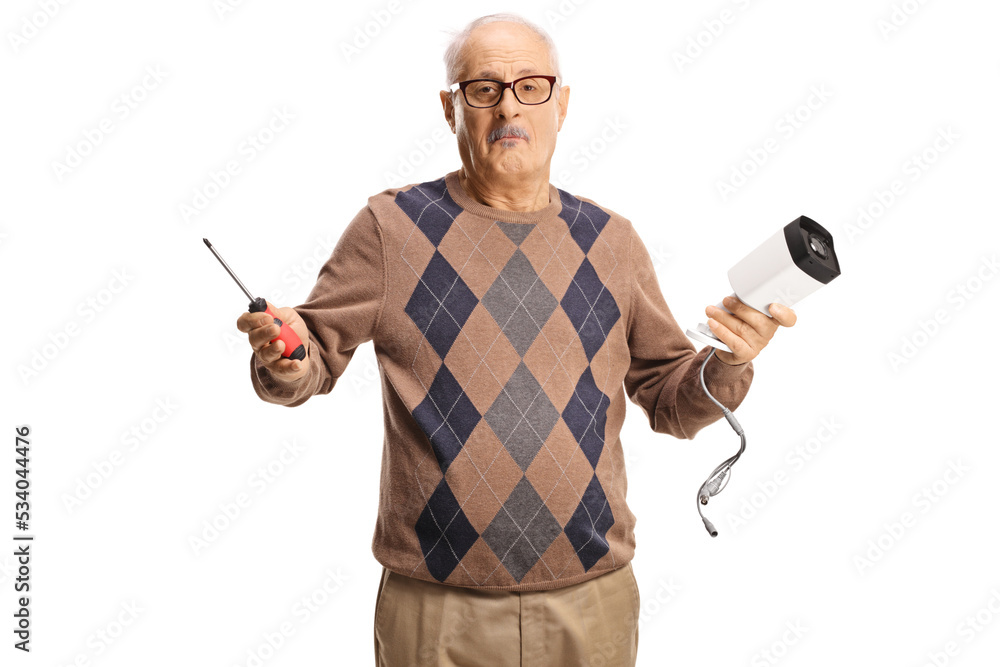 Confused mature man holding a security camera and a screwdriver Confused mature man holding a security camera and a screwdriver