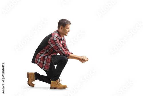 Young man kneeling and holding grain food photo